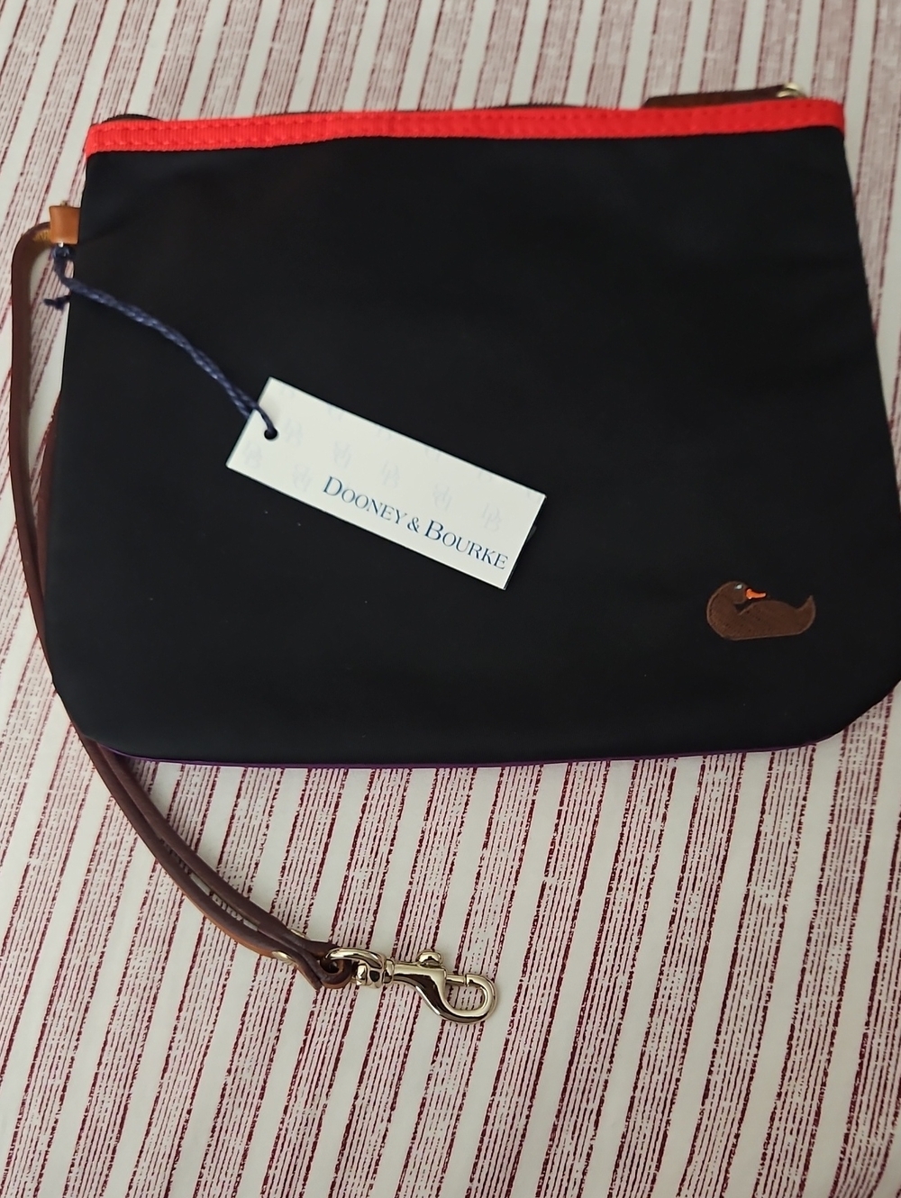 Dooney & Bourke Black Wristlet with Red Trim and Brown Strap and Purple Back